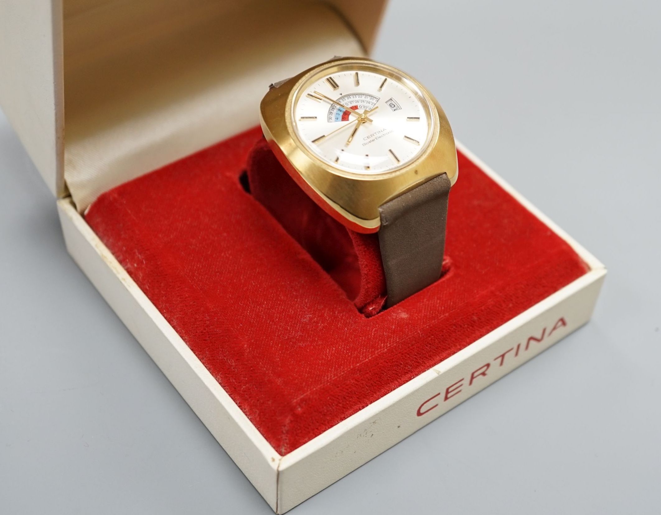 A gentleman's 1970's gilt and steel Certina Biostar Electrinic wrist watch, on Certina strap, case diameter 39mm, with Certina box.
